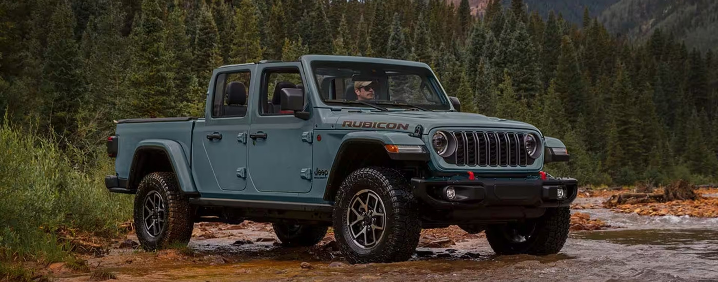 A grey 2025 Jeep Gladiator from the front at an angle Jeep dealer near Fulshear.