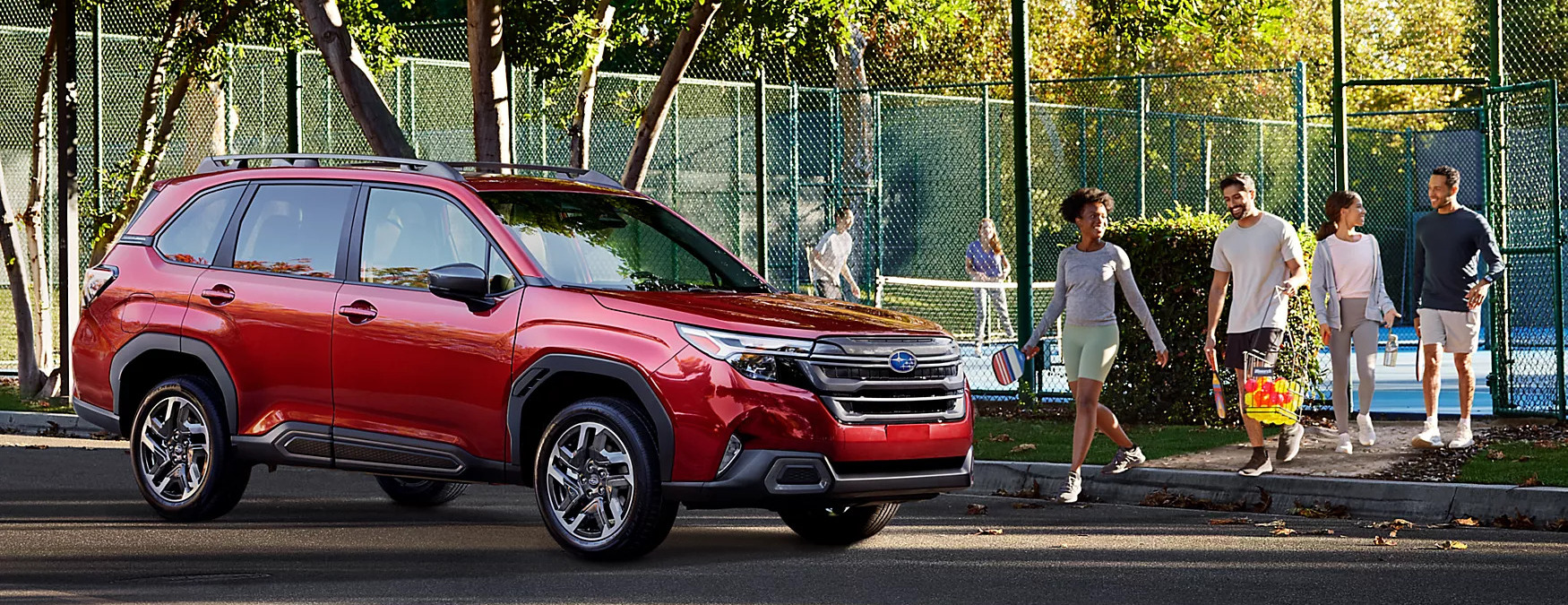 2025 subaru forester hybrid parked next to a tennis court