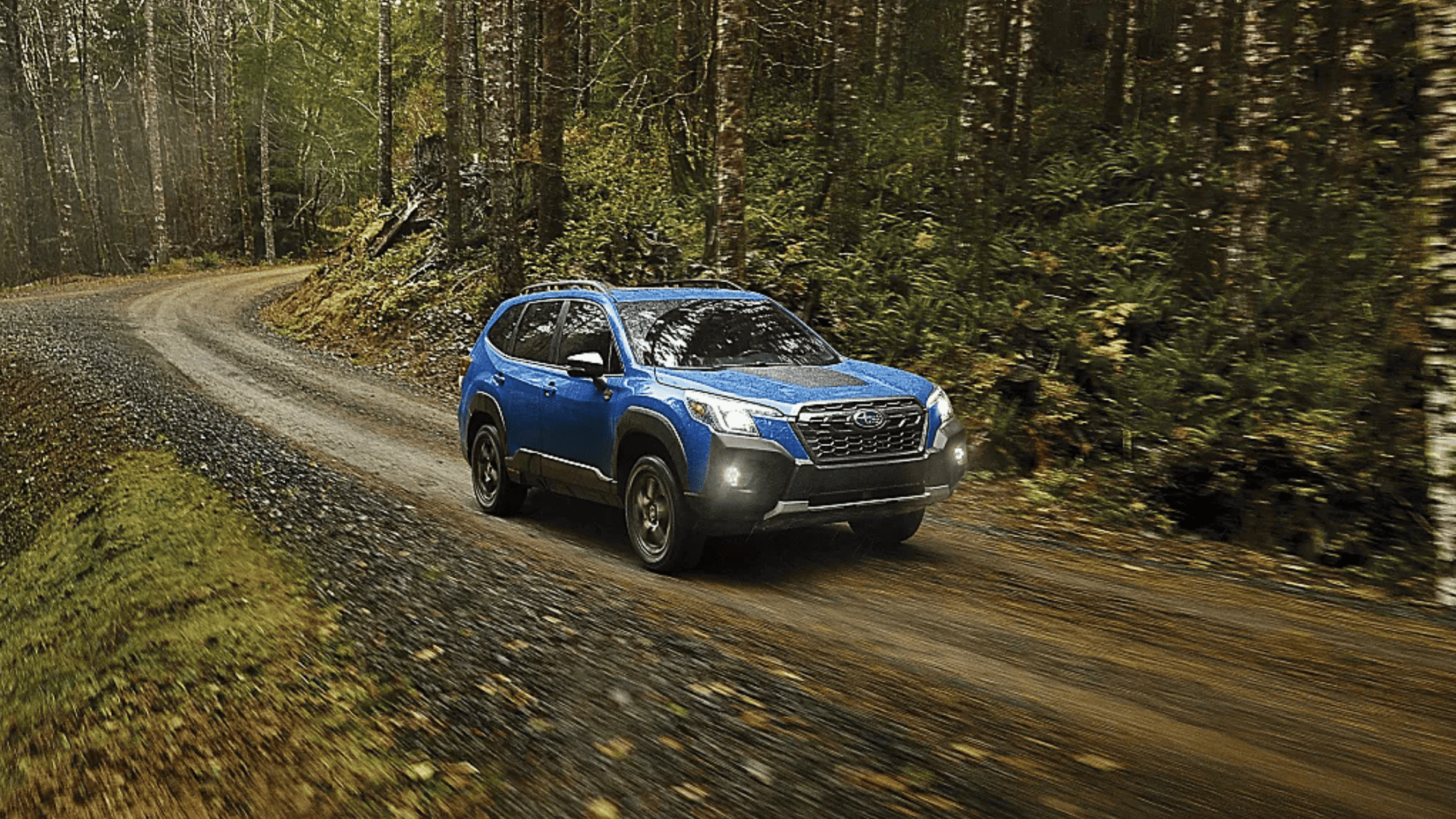 2025 Subaru Forester driving through wooded terrain near Beckley, WV, designed for outdoor enthusiasts seeking comfort and capability.