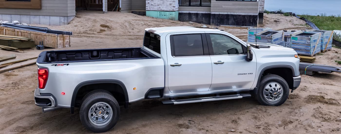 Side of a white 2025 Chevy Silverado 3500 HD at a construction site