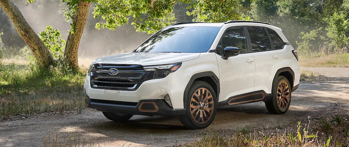 A white Subaru Forester SUV parked on a dirt road 