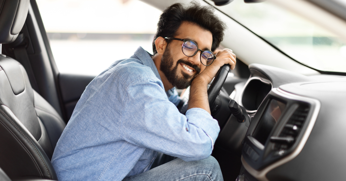 Smiling man enjoying his new Jeep model