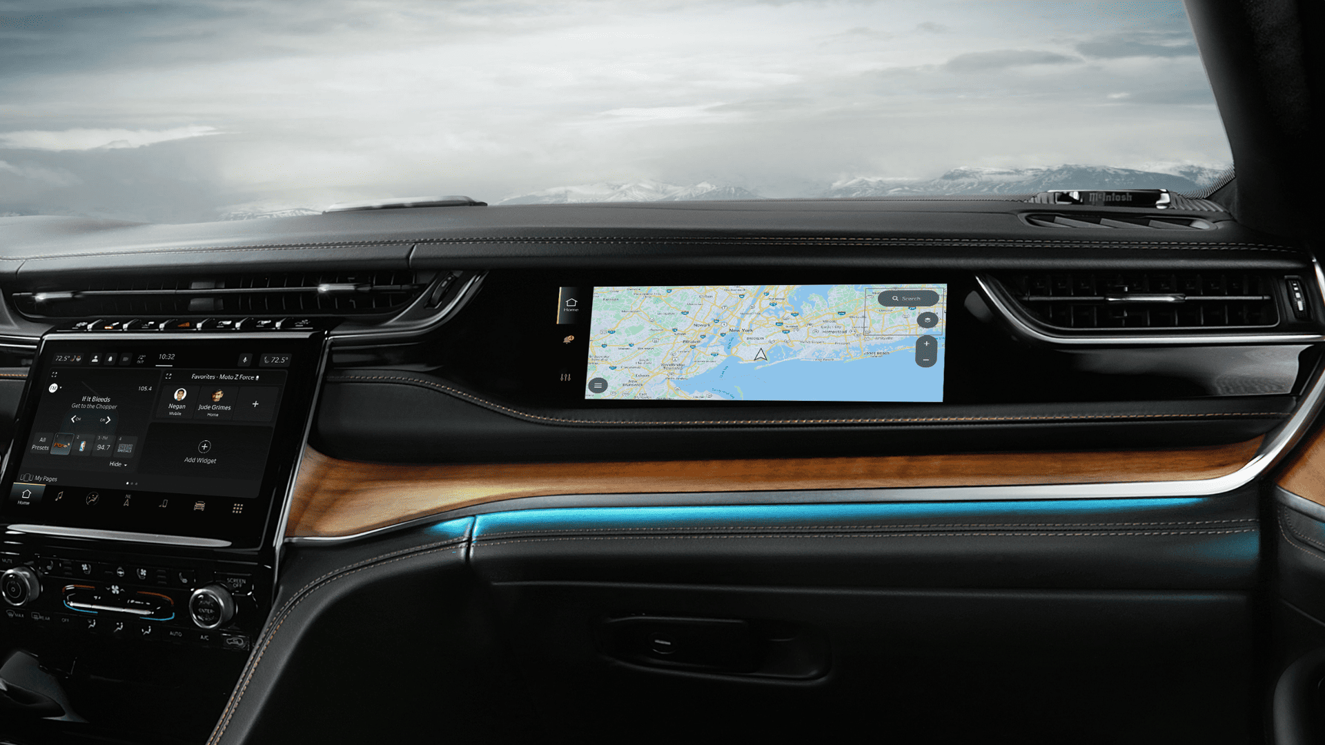 Close-up view of the Jeep&reg; Grand Cherokee interior dashboard featuring a dual-screen display with navigation and media controls.