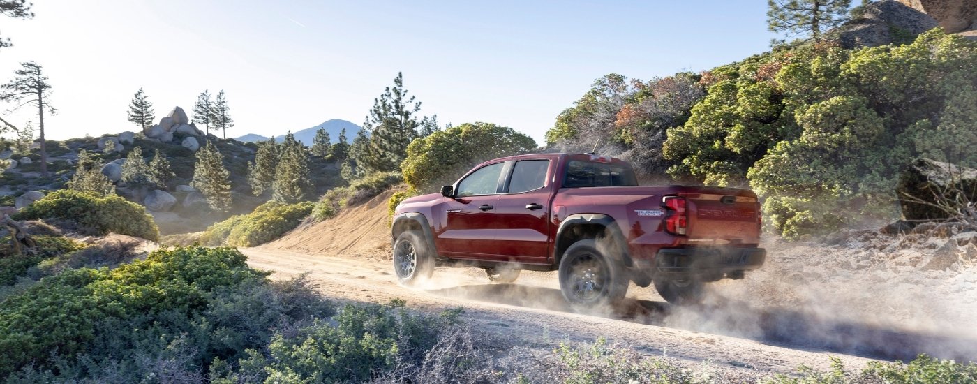 A red 2025 Chevy Colorado Trail Boss from the side after leaving a Chevy dealer near Brenham.