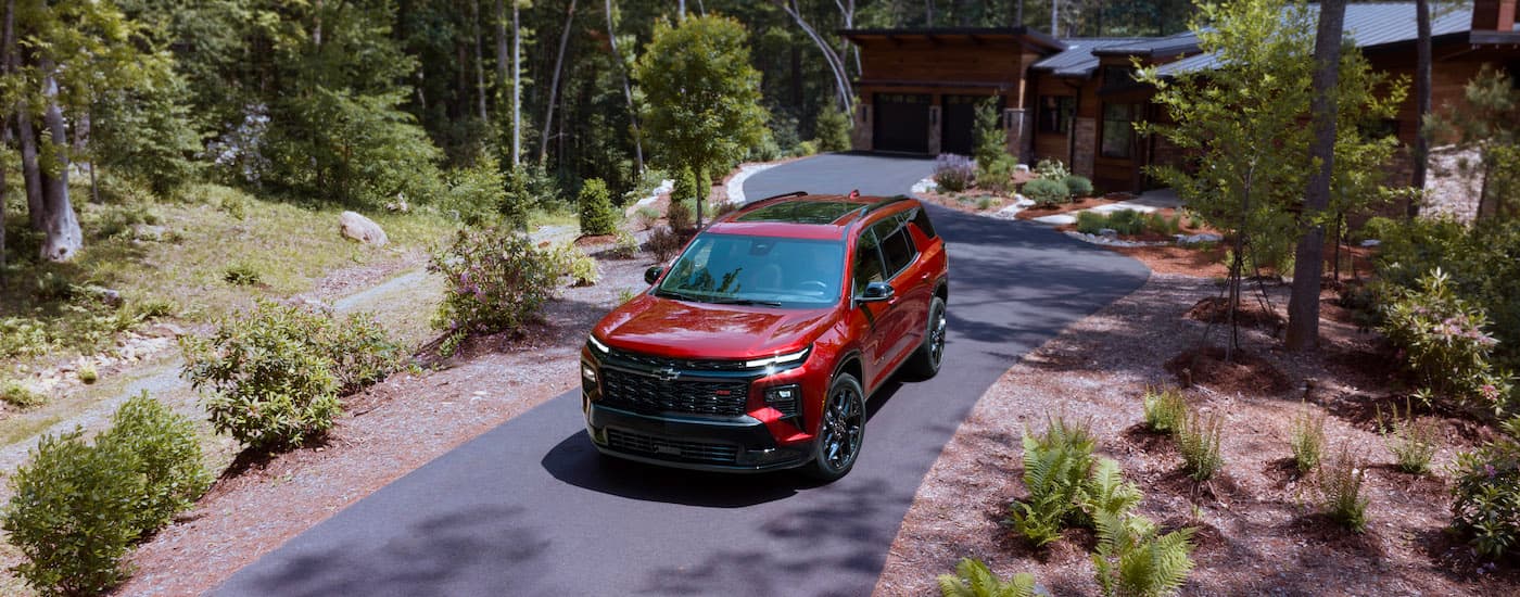 A red 2025 Chevy Traverse for sale from the front.