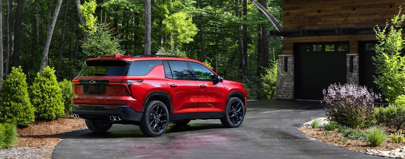 A red 2025 Chevy Traverse from the rear at an angle.