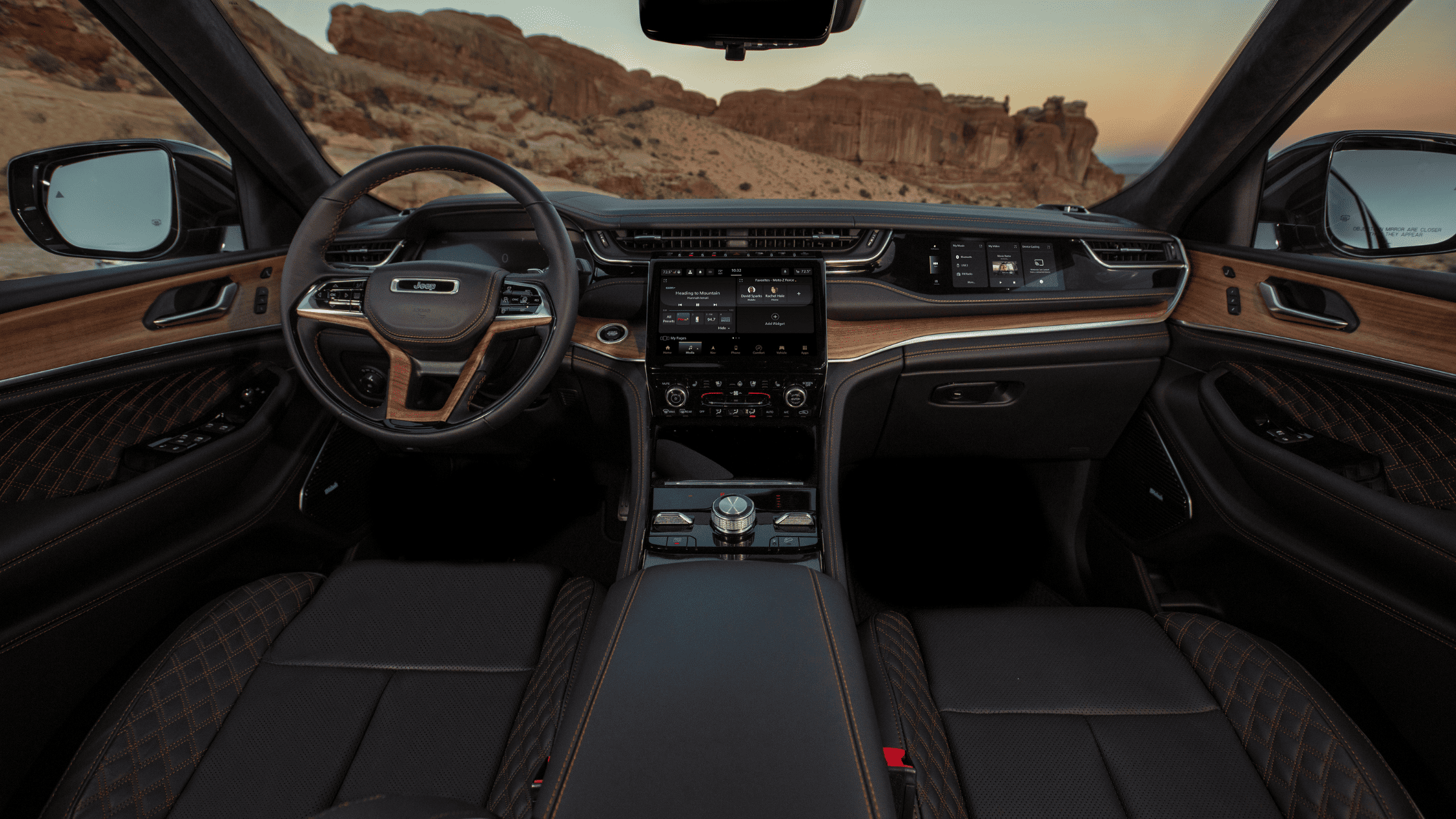 Luxurious 2026 Jeep&reg; Grand Cherokee interior with premium leather seats and wood-accented dashboard.