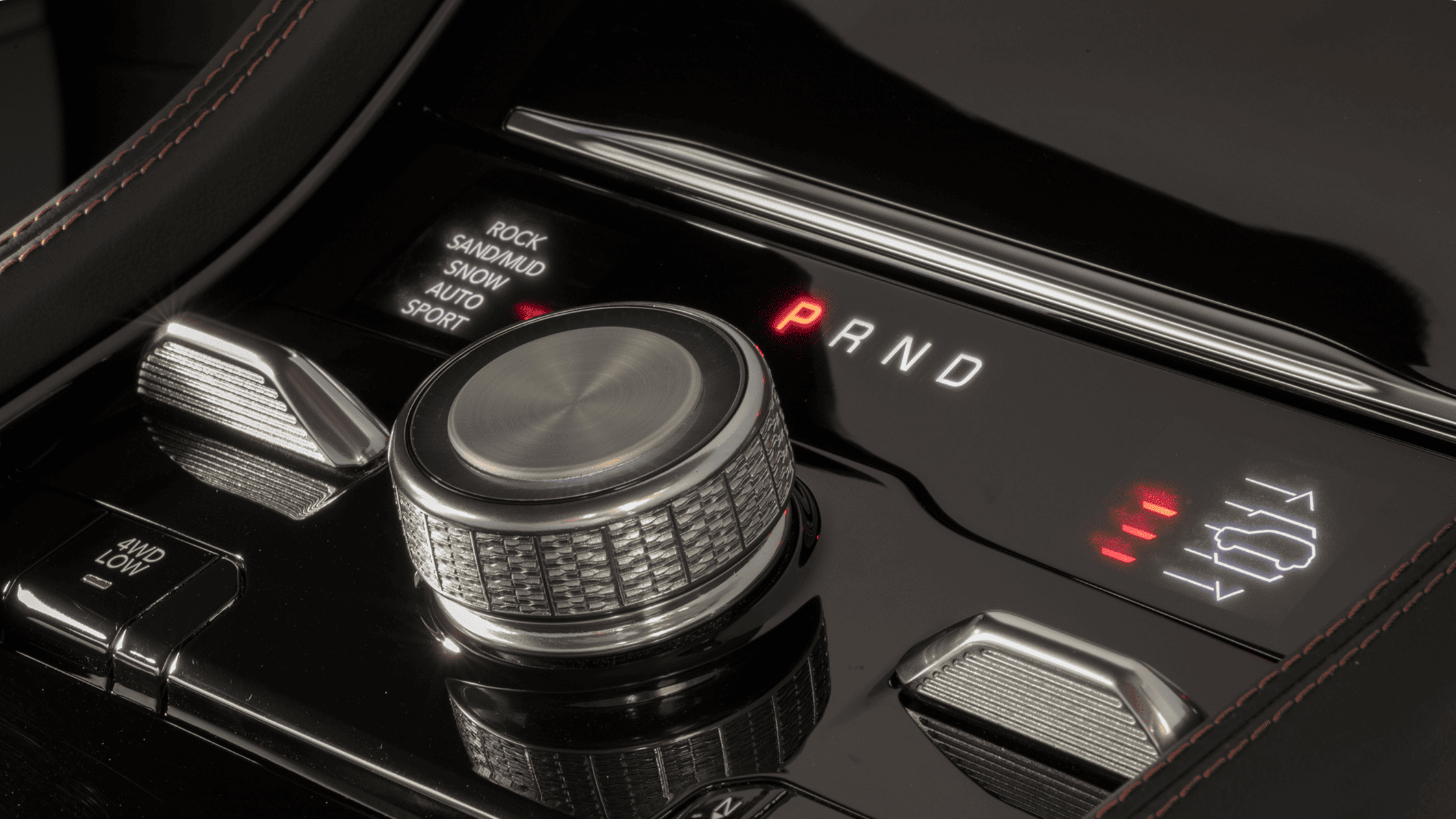 Close-up of 2026 Jeep&reg; Grand Cherokee drive mode selector showcasing terrain and traction settings.