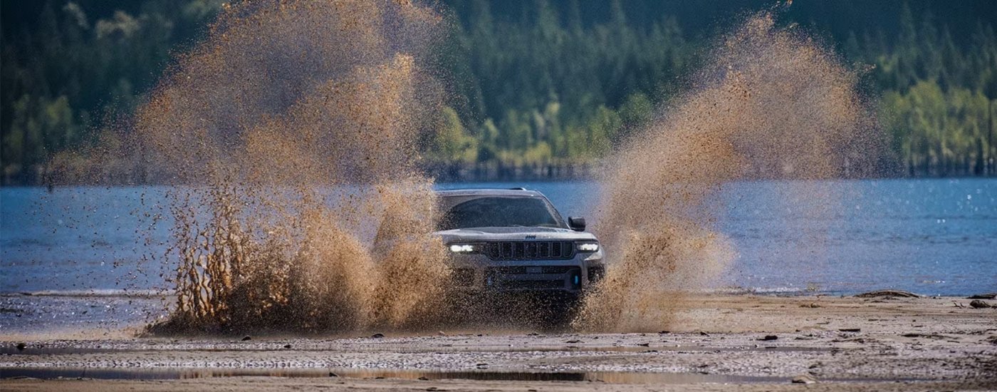 A grey 2025 Jeep Grand Cherokee from the front.