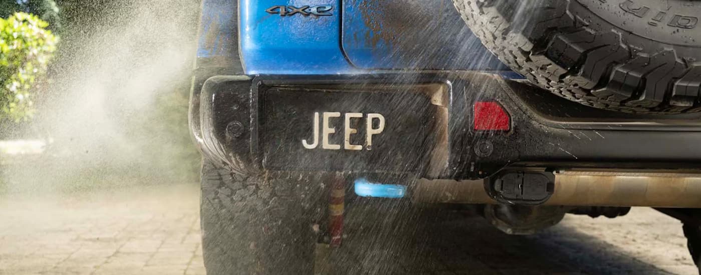 Blue 2025 Jeep Wrangler for sale near Magnolia being cleaned