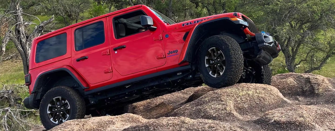 A red 2025 Jeep Wrangler from the side after leaving a Jeep dealer near me.