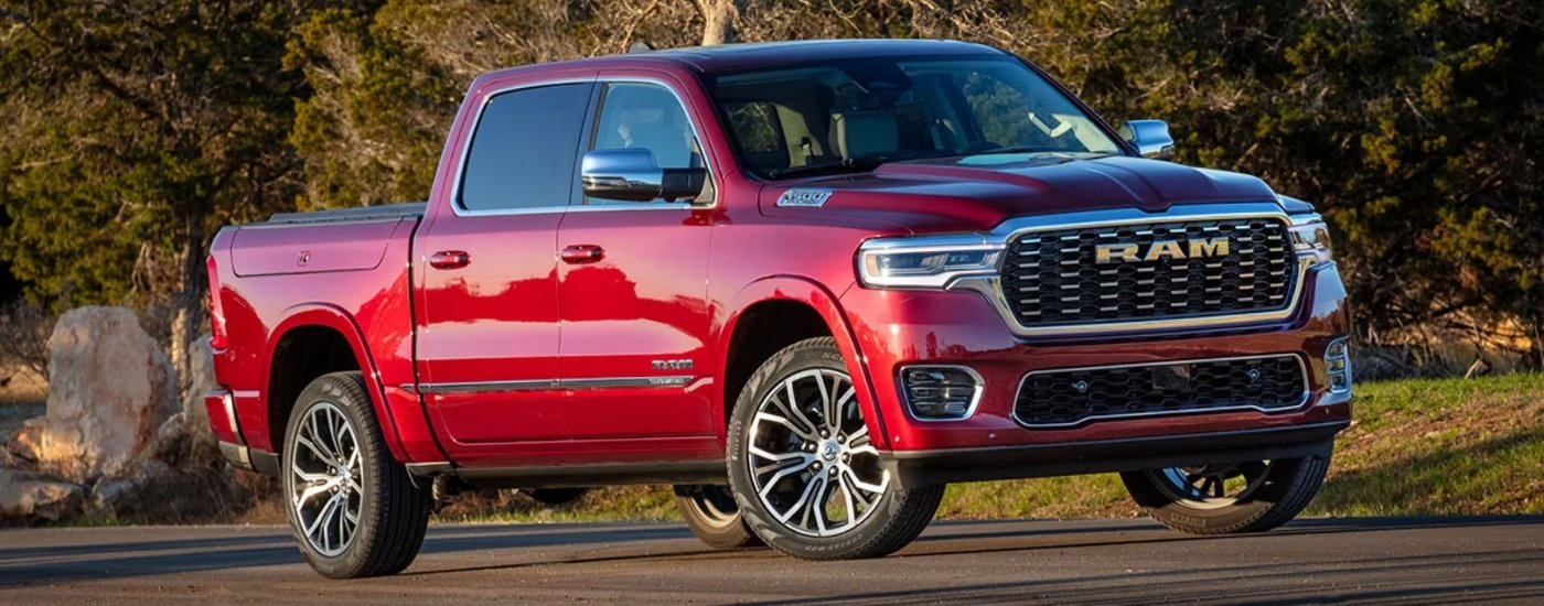 A red 2025 Ram 1500 from the front at an angle.