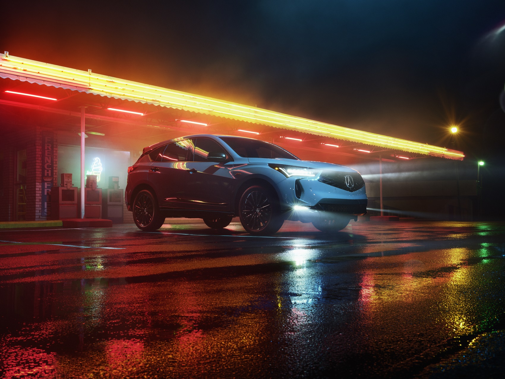 Acura parked at night in the rain 