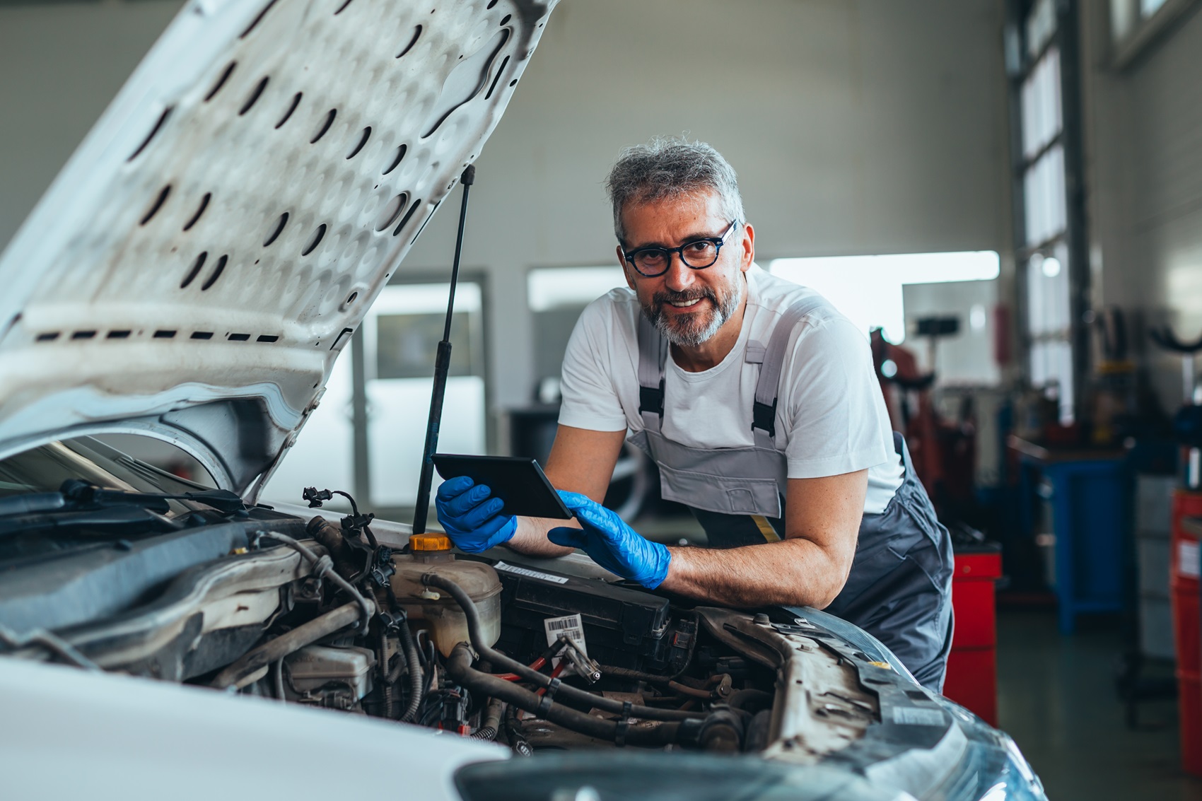 Service technician working on Acura vehicle maintenance 