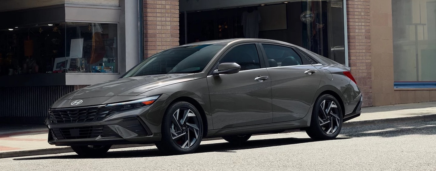 A grey 2024 Hyundai Elantra from the side after used car dealer.