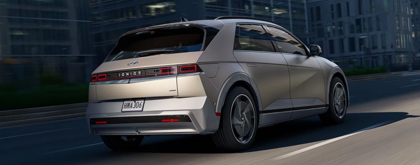 A tan 2024 Hyundai IONIQ 5 from the rear.