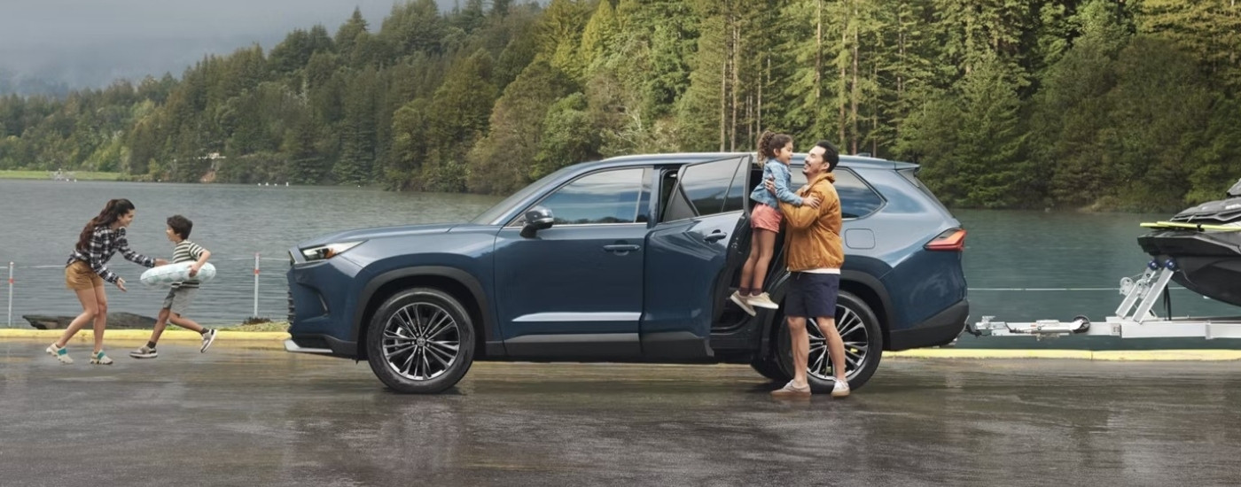 A blue 2025 Toyota Grand Highlander from the side.
