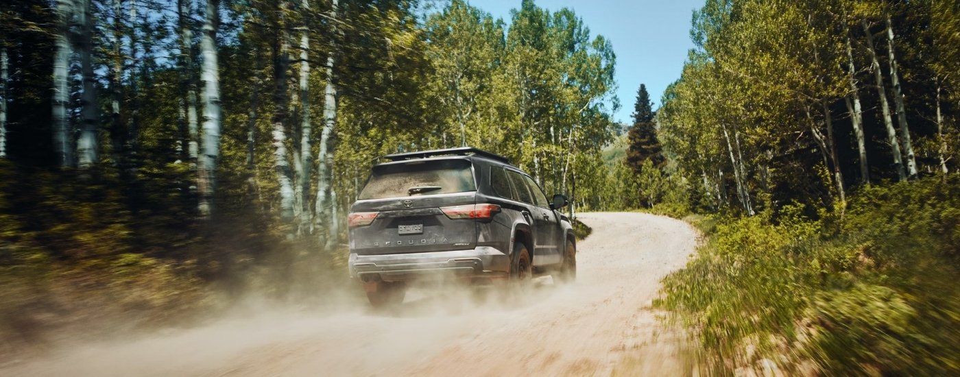 A blue 2025 Toyota Sequoia from the rear at an angle.