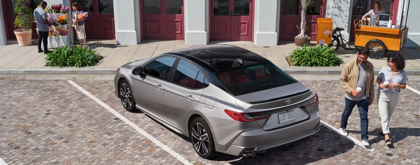A silver 2025 Toyota Camry from the rear at an angle.
