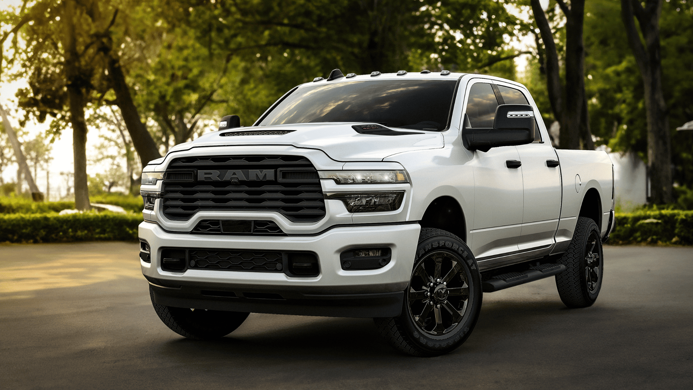 White 2026 Ram Heavy Duty truck parked outdoors highlighting its rugged grille and muscular stance.