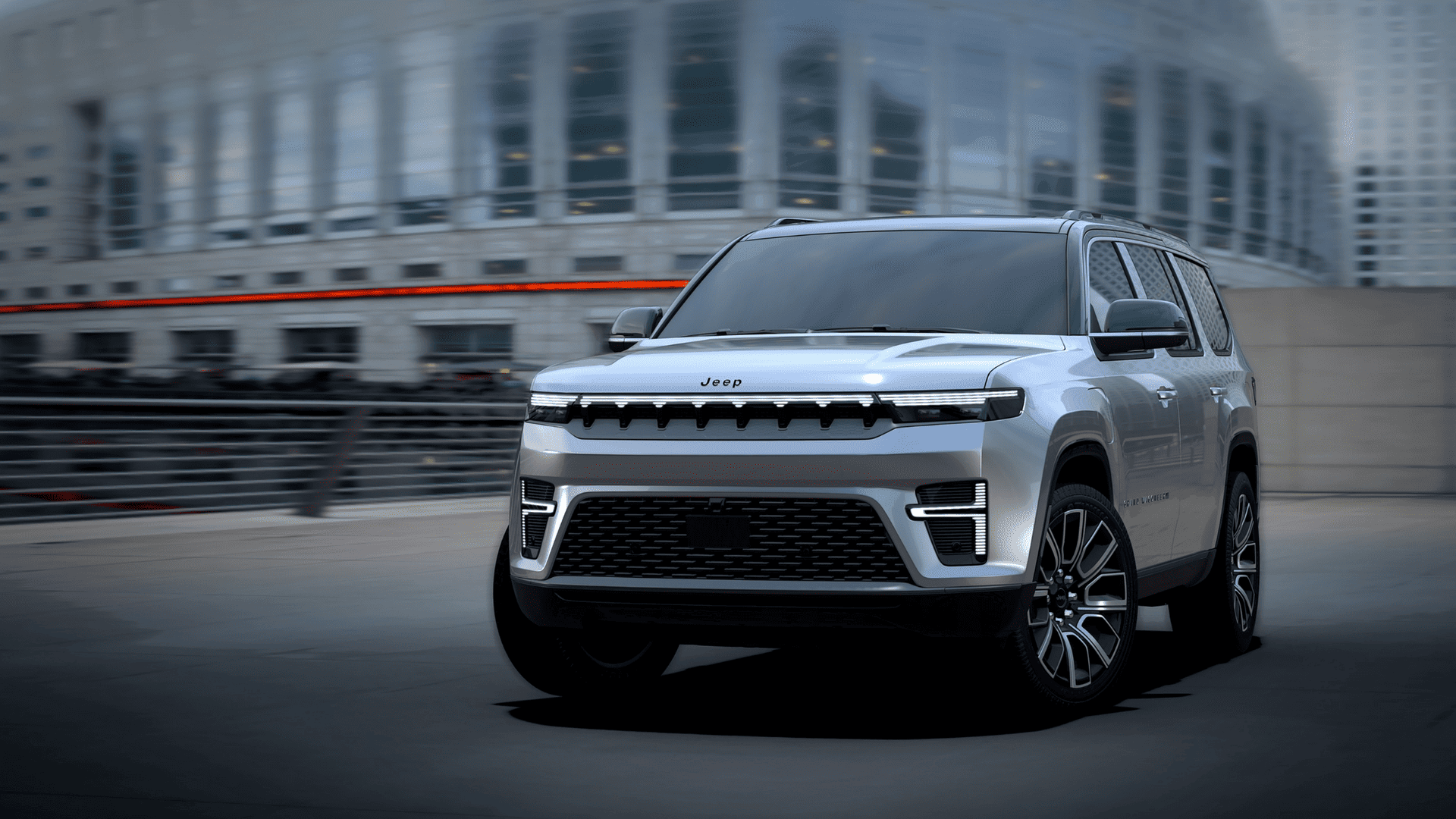 Silver 2026 Jeep Grand Wagoneer parked in a modern city setting.