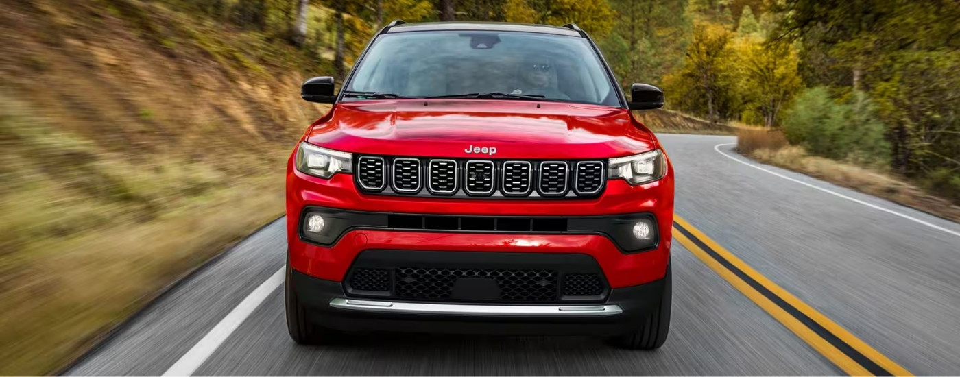 A red 2025 Jeep Compass from the front.