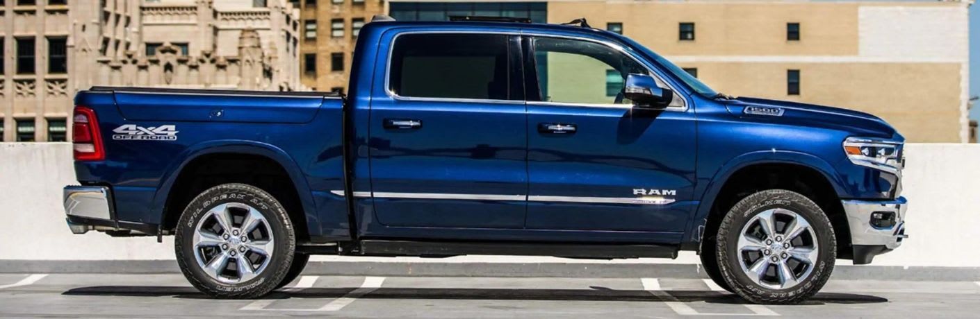 Hydro Blue Pearl RAM 1500 parked in front of a building 