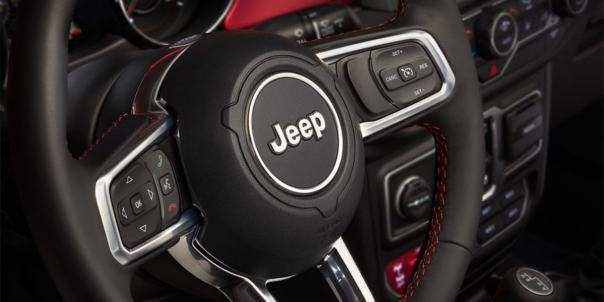 Jeep Dealer Longview, TX - interior of Jeep showing steering wheel with Jeep logo