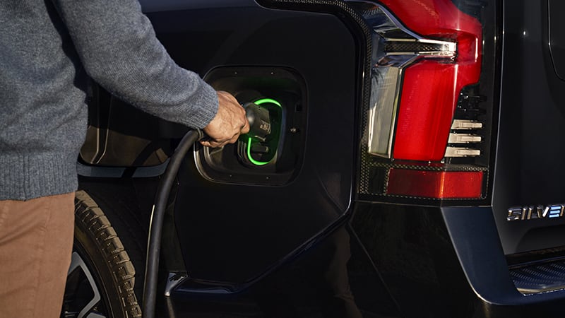 Someone putting charger into their 2024 Silverado EV Chantilly, VA