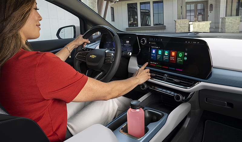 Woman pressing touchscreen infotainment system Woman pressing touchscreen infotainment system