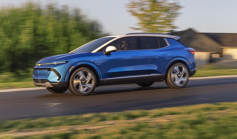 Bright blue 2024 Chevy Equinox EV on the road Bright blue 2024 Chevy Equinox EV on the road