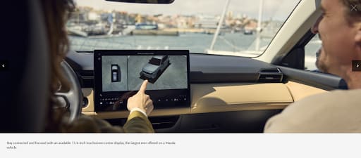 Passenger using the 15.6-inch 2026 Mazda CX-5 touchscreen center display