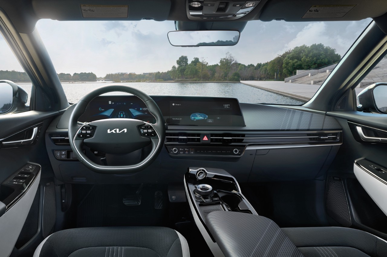 Driverside Interior View of the seats, console, and dashboard overlooking a body of water