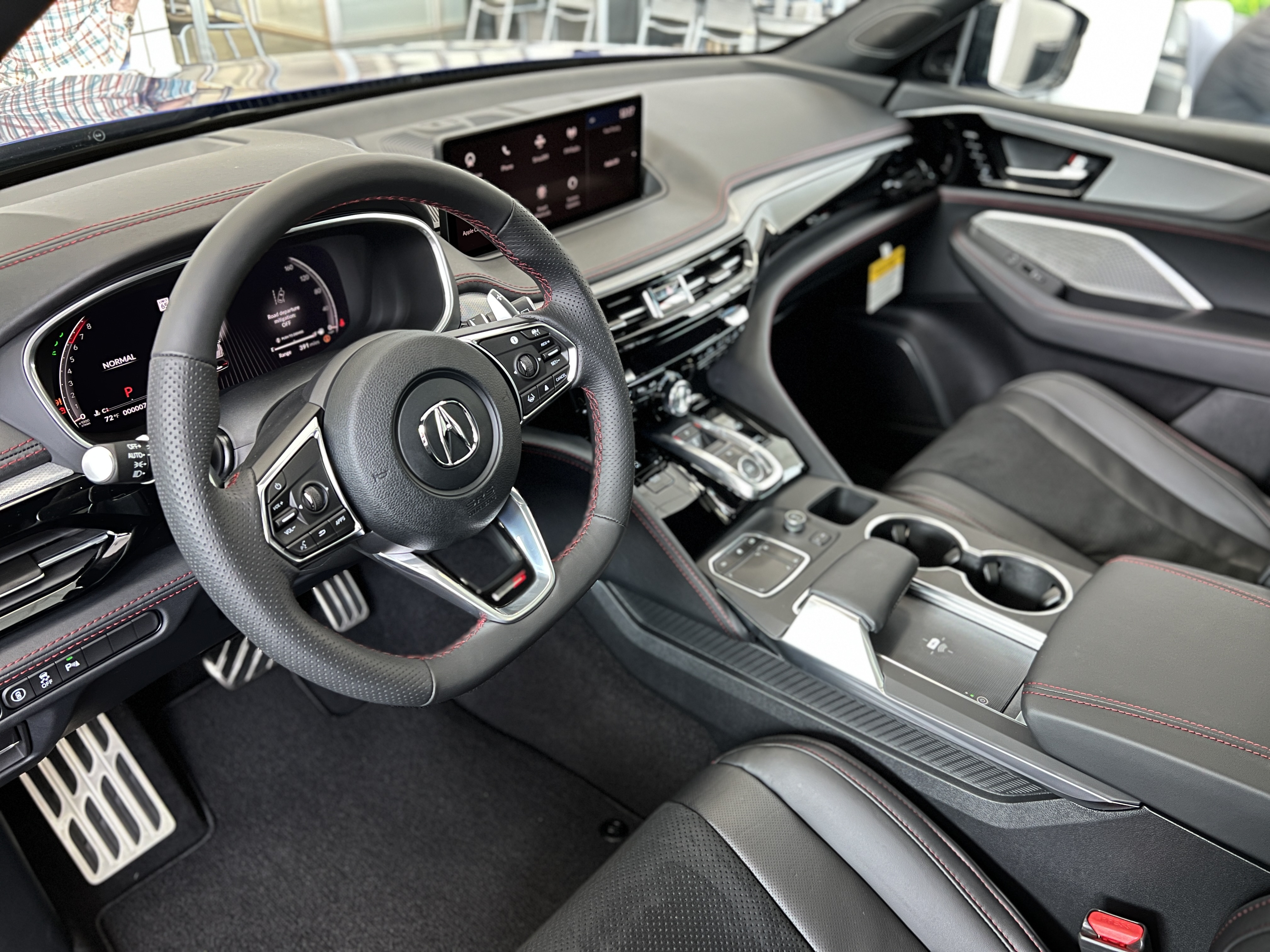 Interior from the driver perspective of the dashboard and front seating