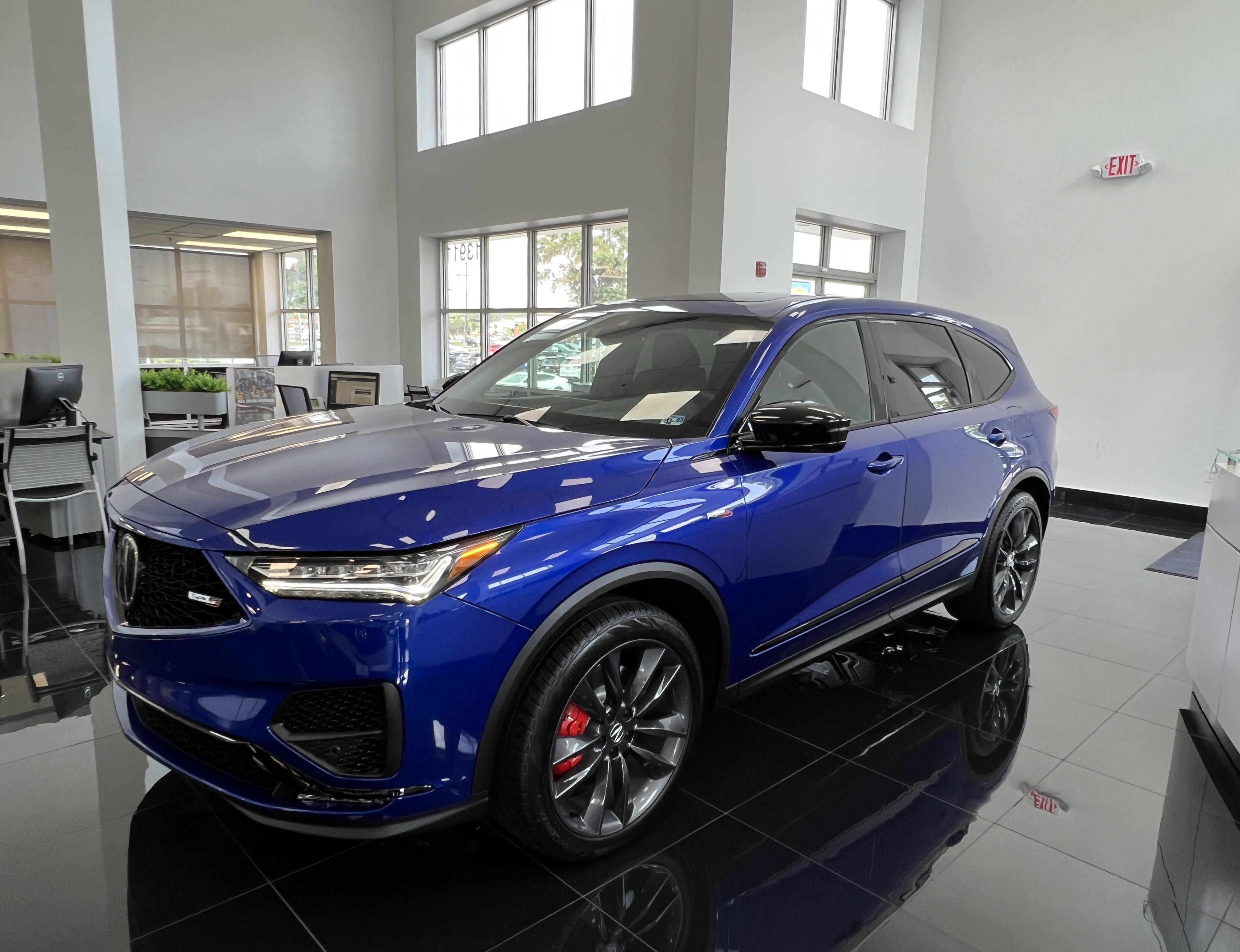 Front and driver side view of blue Acura MDX