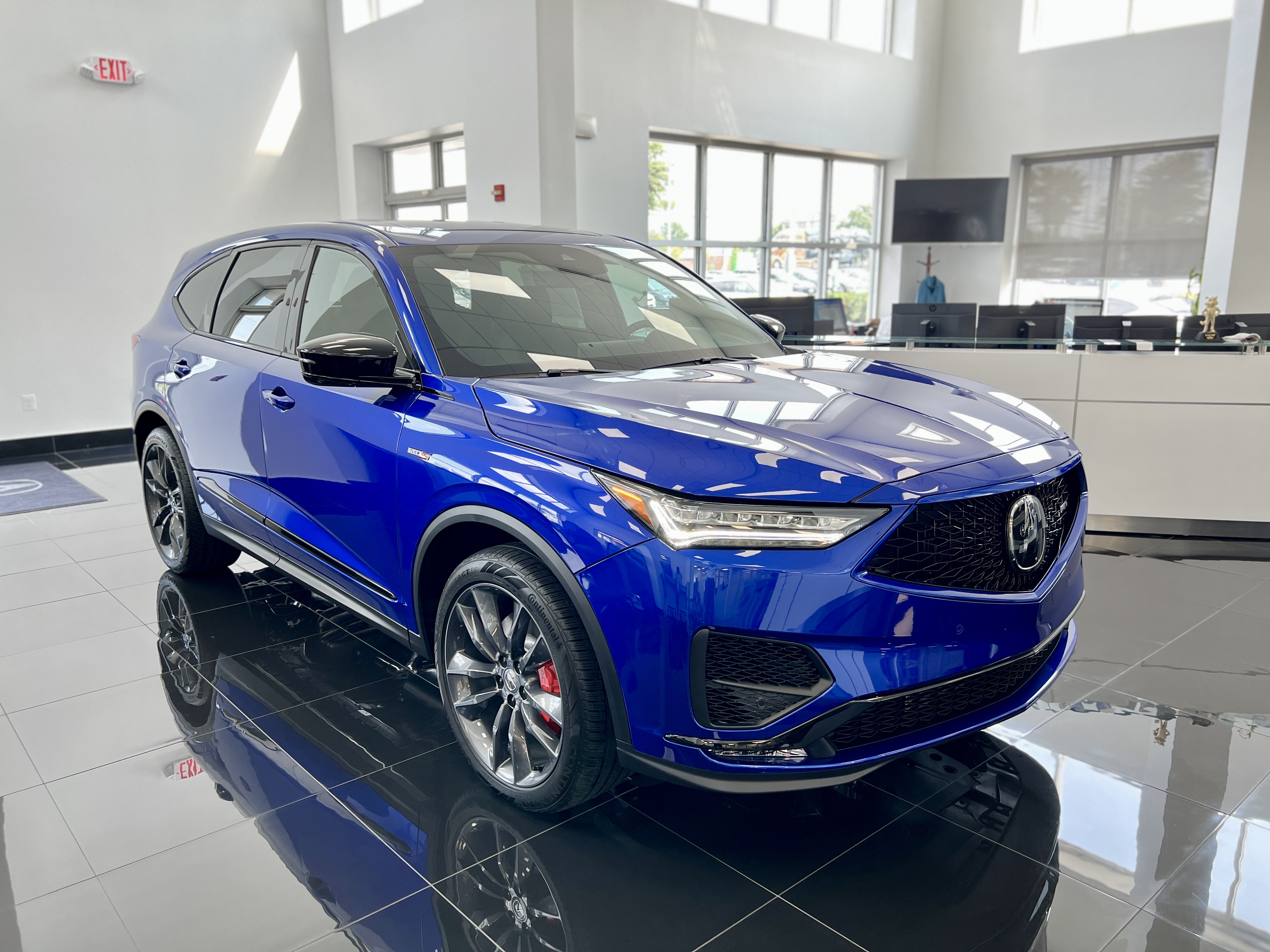 Front and passenger side view of blue Acura MDX