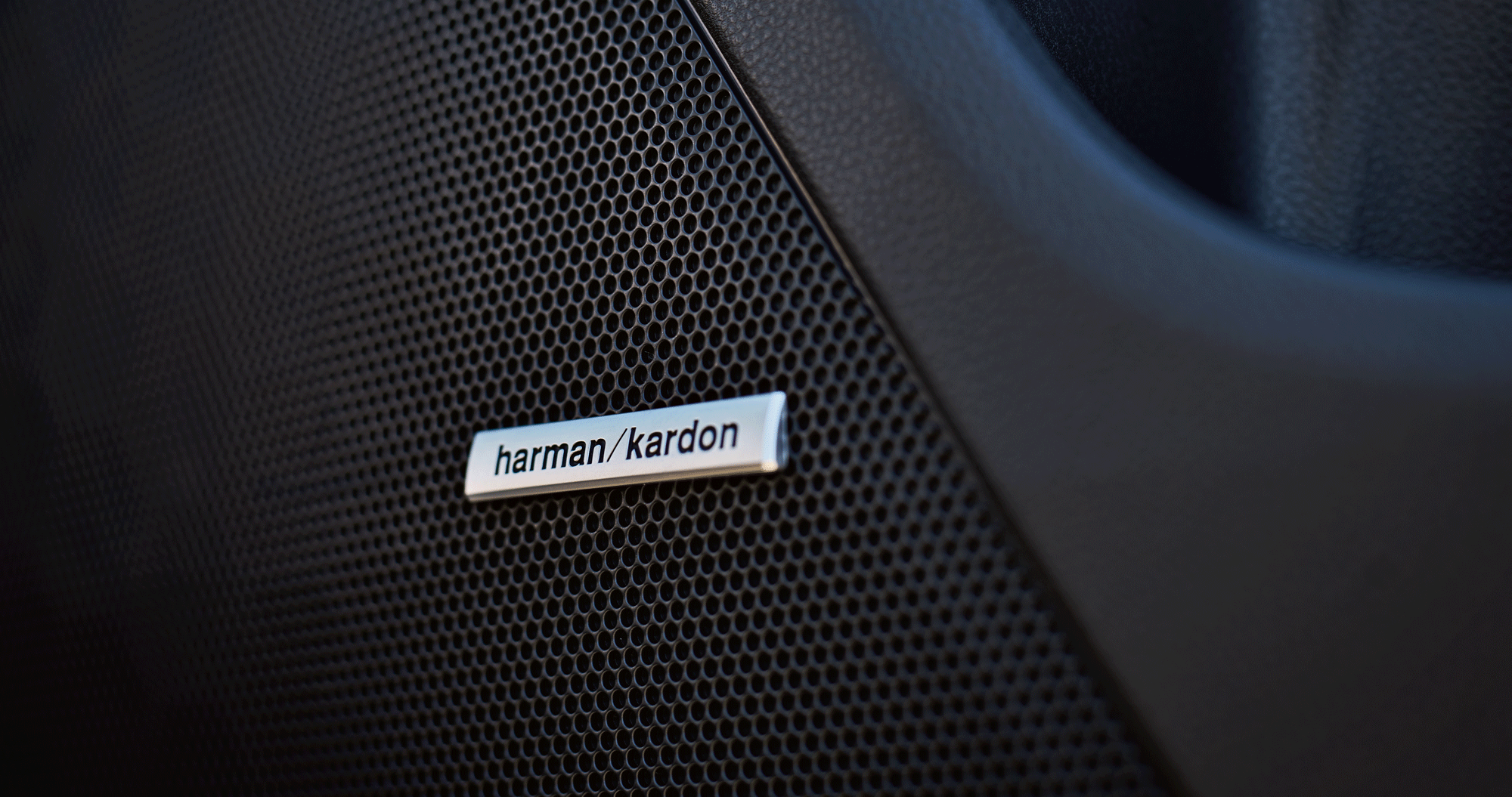 A close-up of one of the speakers of the Harman Kardon premium audio system available on the 2023 Crosstrek.