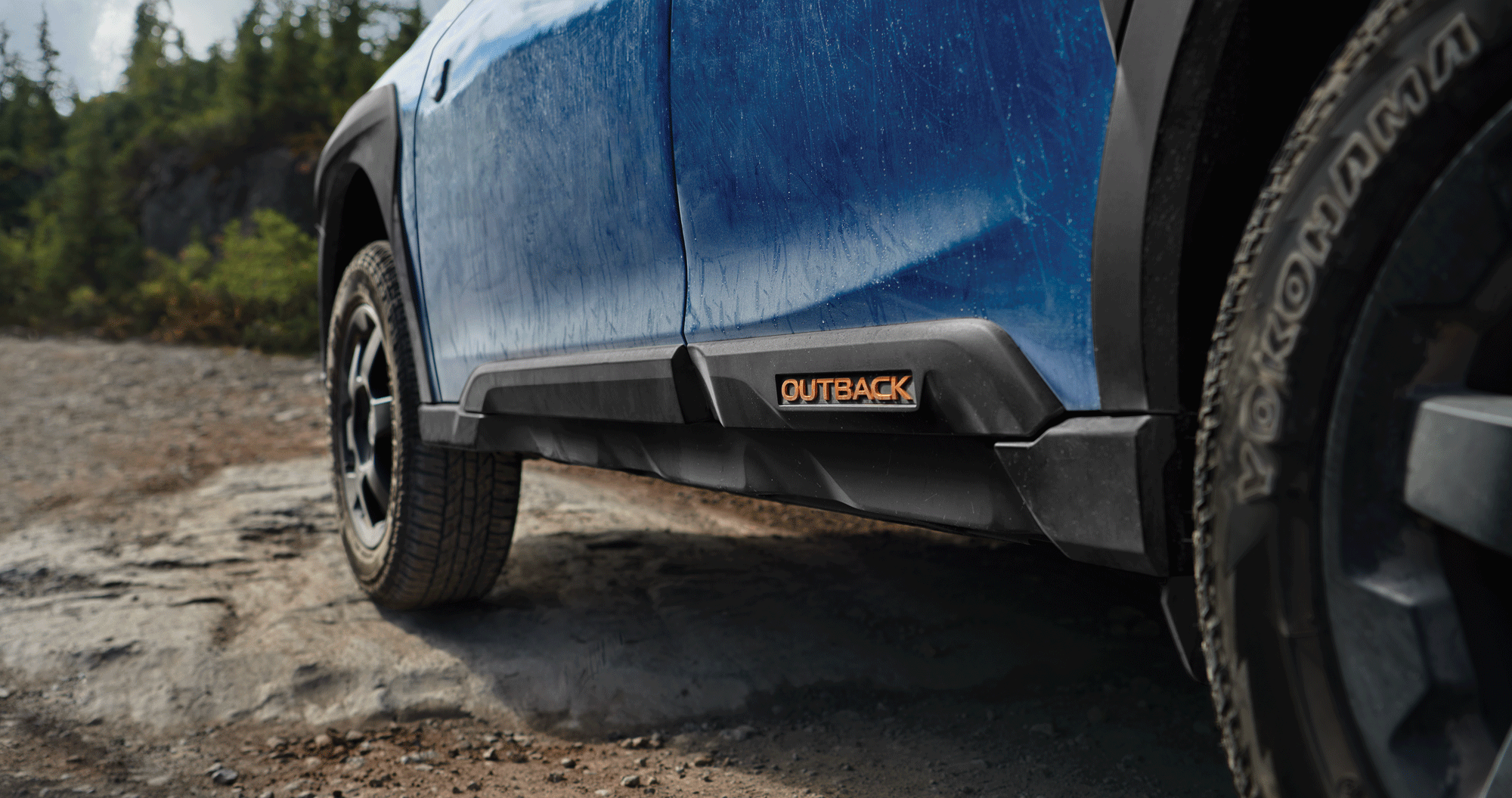 A close-up of the rugged exterior trim and cladding on the 2023 Outback Wilderness.
