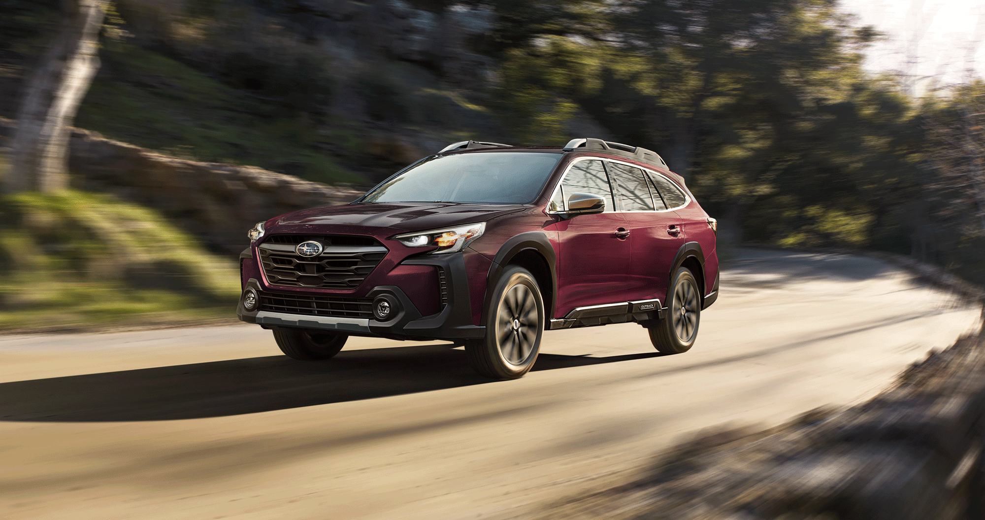 A 2023 Outback driving on a highway.
