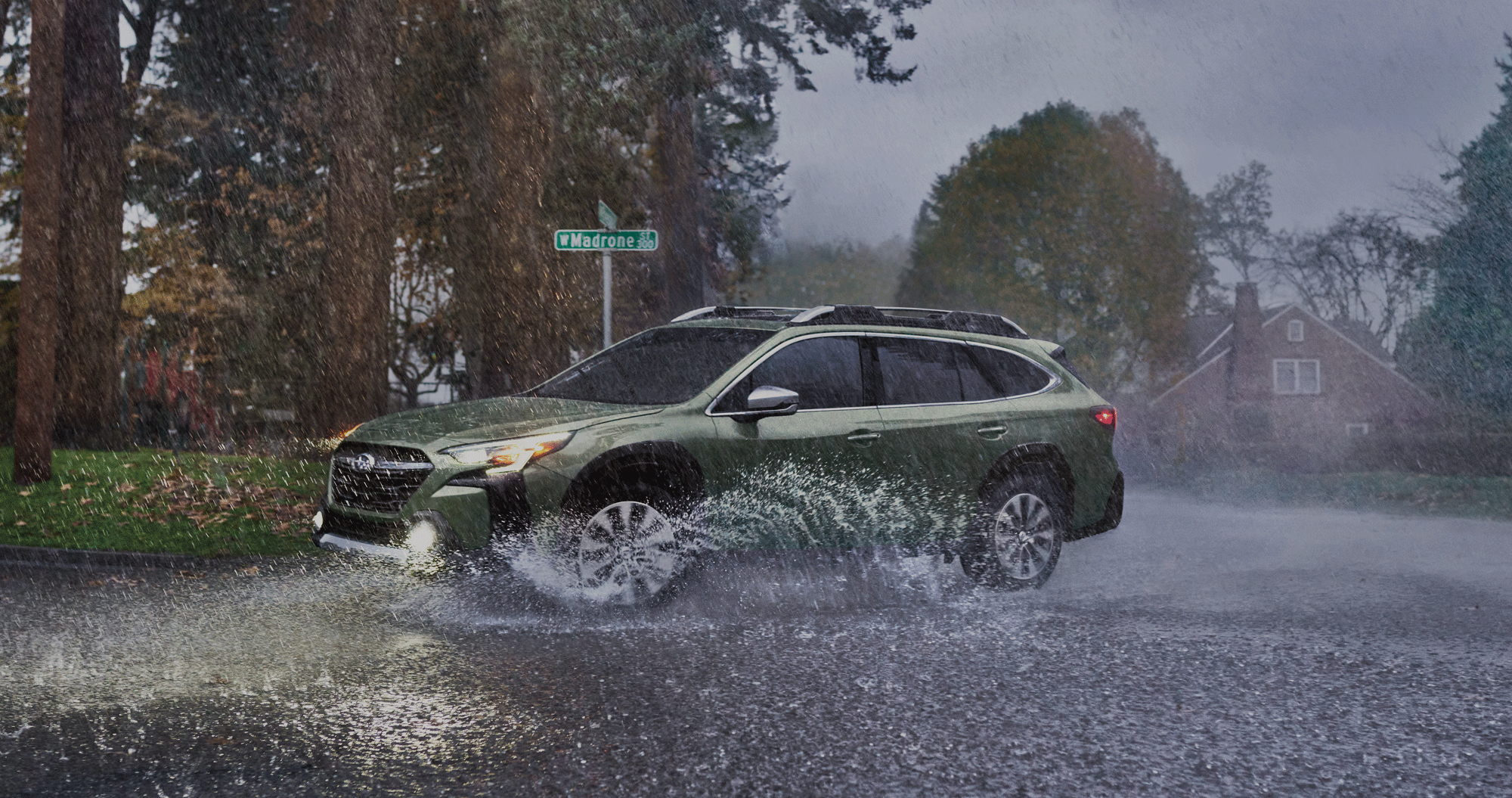 A 2023 Outback driving on a rainy street.