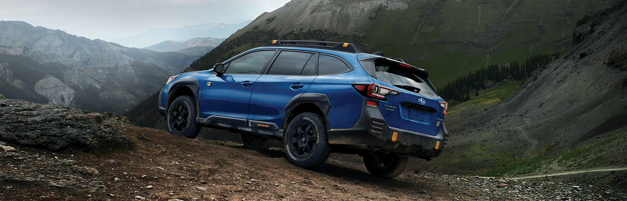 A 2023 Outback Wilderness parked in the mountains.
