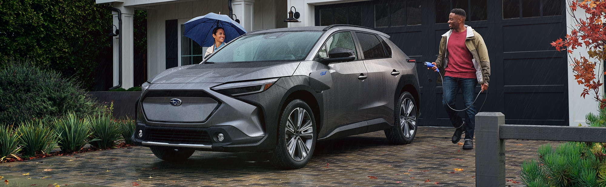 A couple charging their 2023 Solterra.