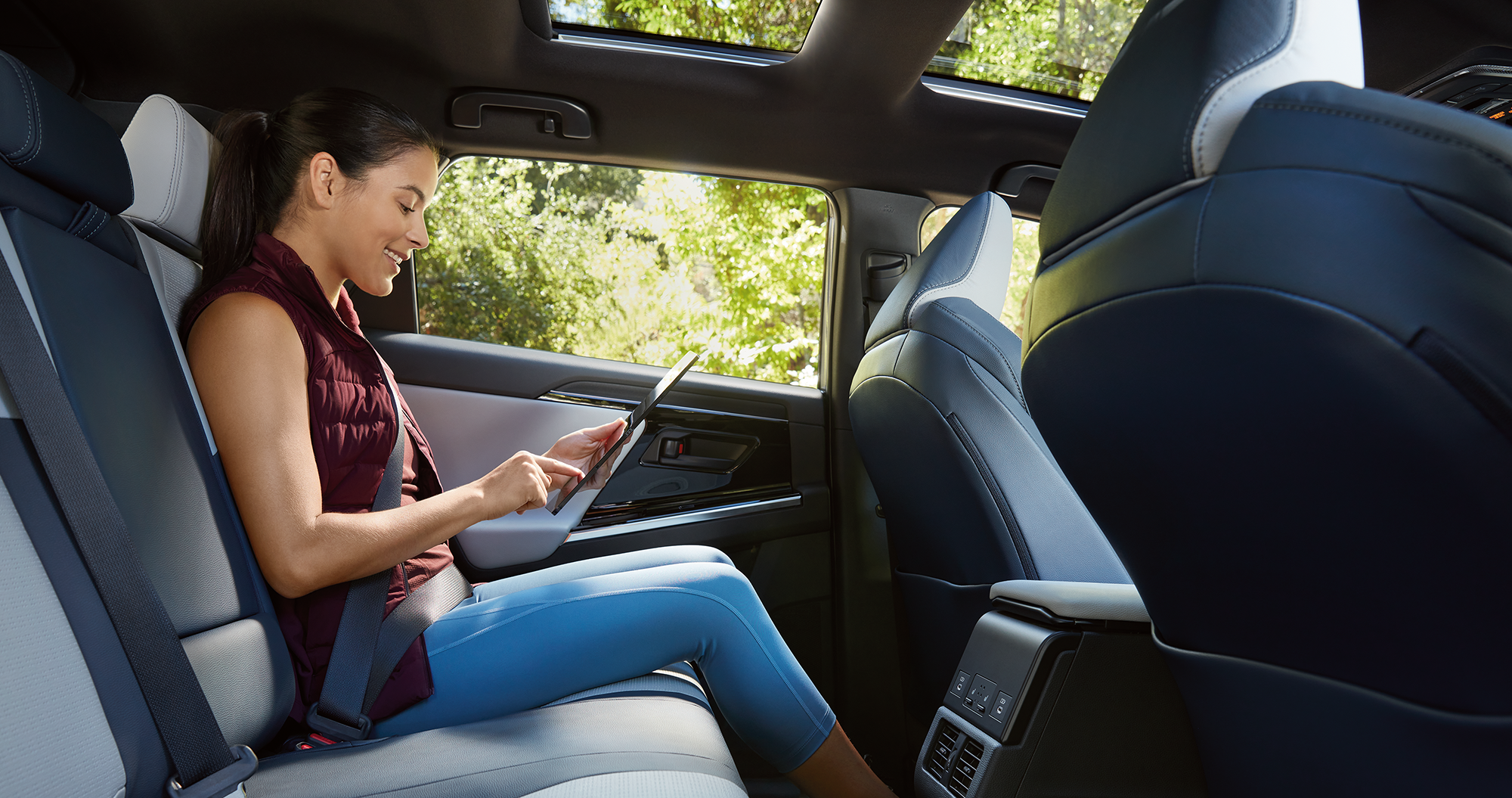A woman sitting in a rear seat inside the 2023 Solterra.