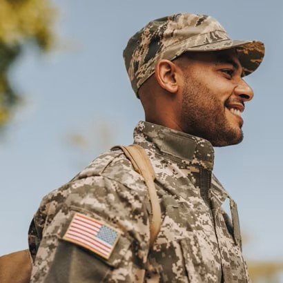 A smiling man dressed in a military uniform