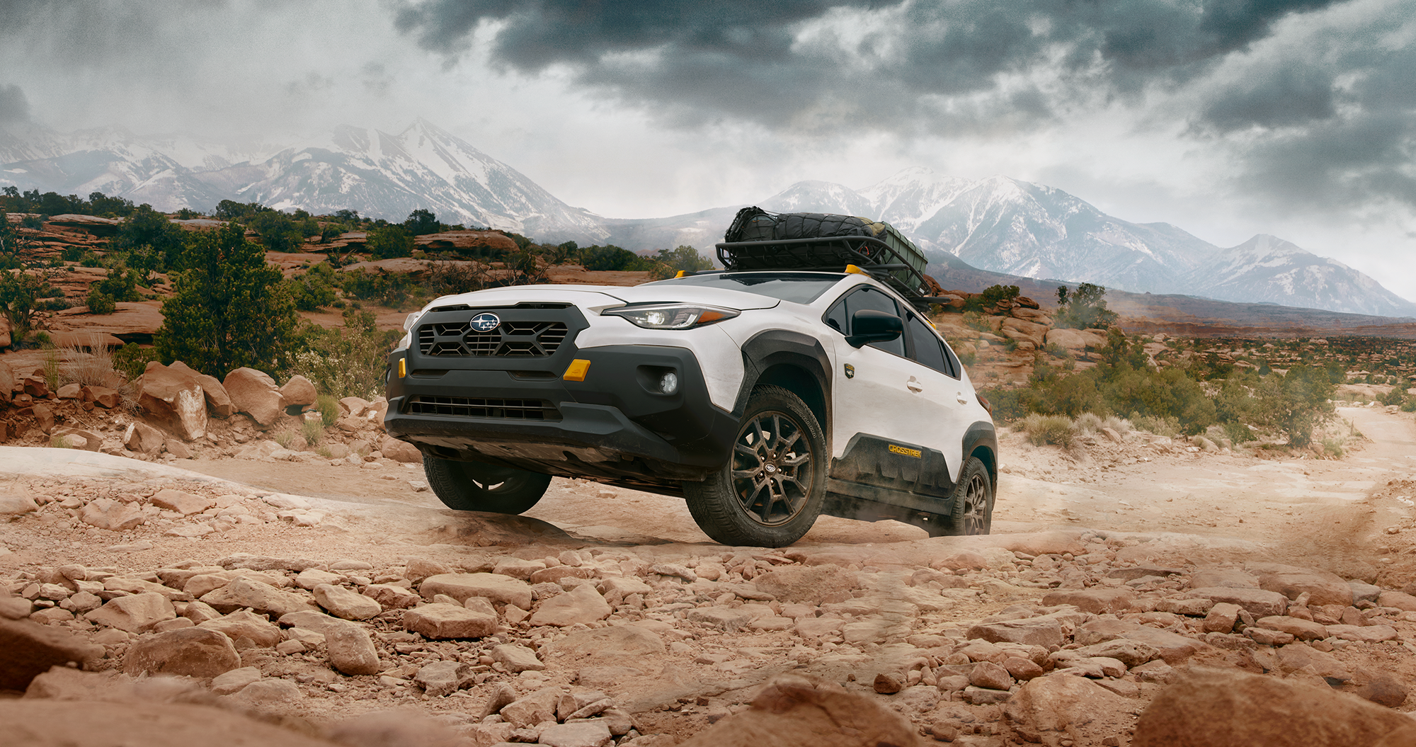 2026 Crosstrek Wilderness cresting over rocks.