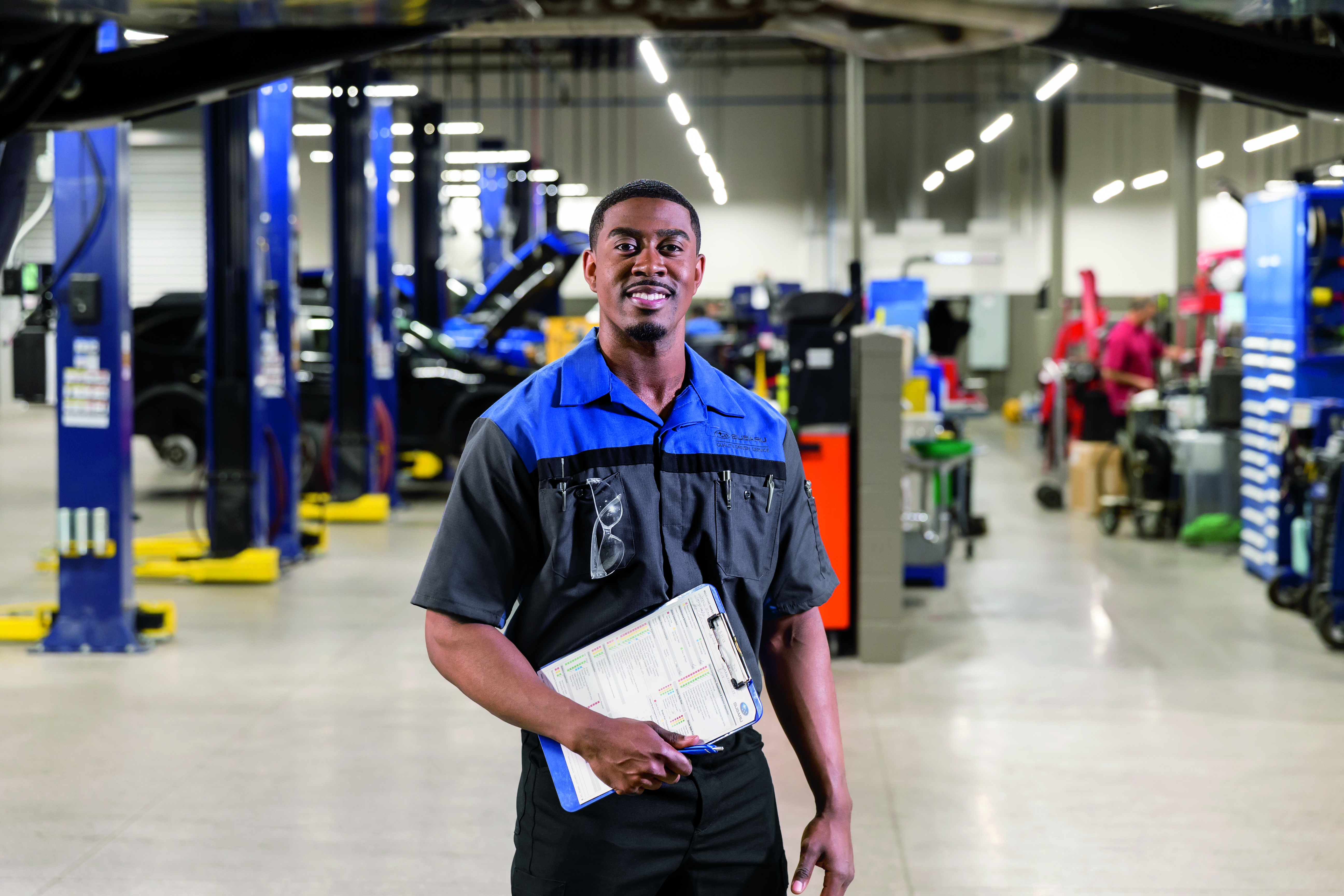 Image of service representative smiling and holding a clipboard.