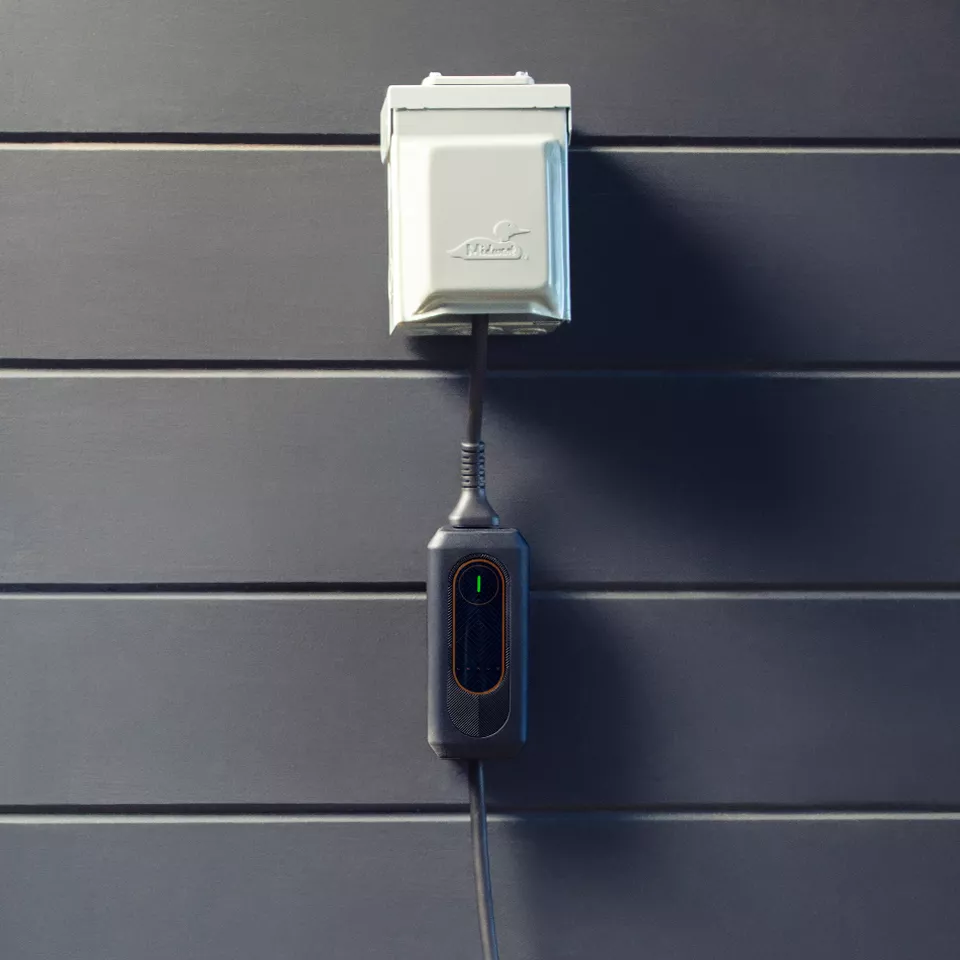 Lexus mobile charger hanging from outlet.
