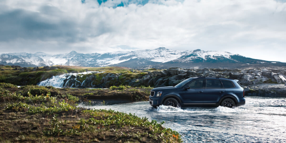 2025 Kia Telluride Exterior Driving Through Waterside View