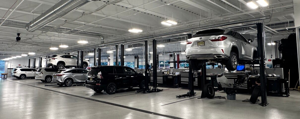 Image of the interior of Ray Catena Lexus of Monmouth's Lexus Service Center with Lexus cars on lifts