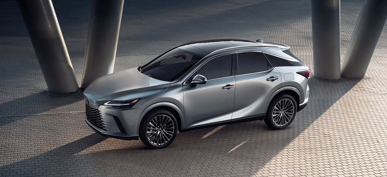 A silver, or Lexus iridium, 2025 Lexus RX 350 parked on a brick path between pillars